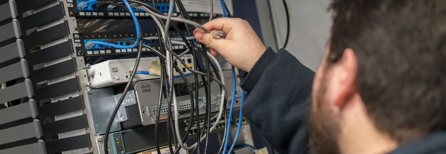 Student working on a network rack