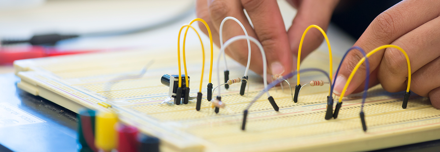 Student working with components on a breadboard