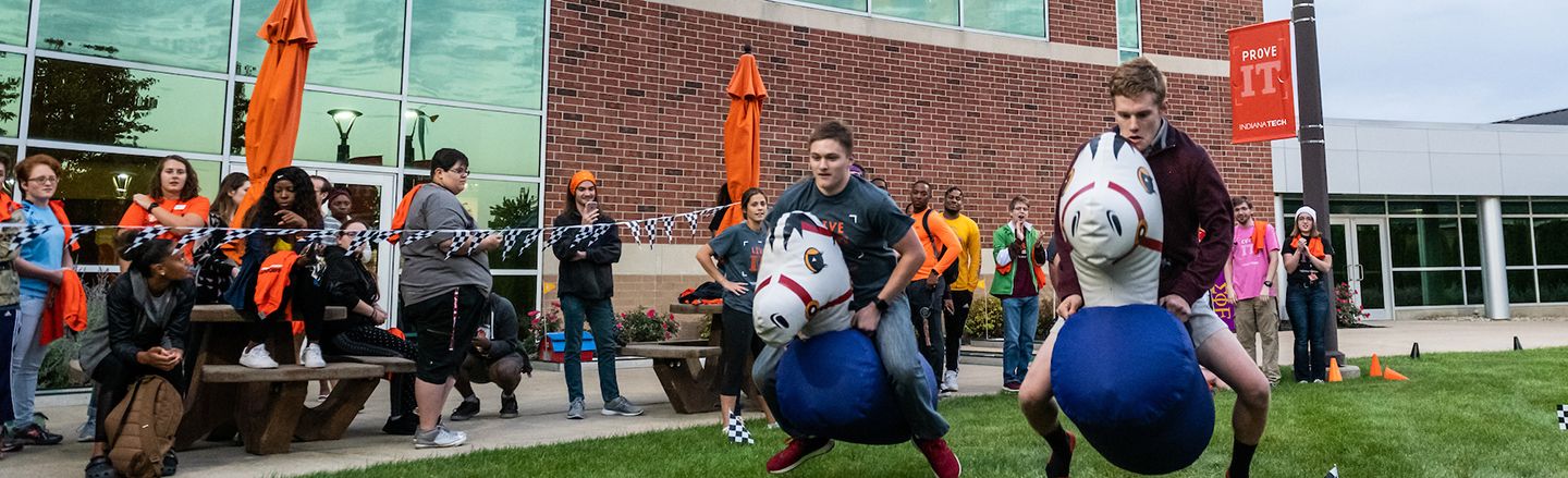 students gathered outside of Andorfer building participating in games during homecoming week