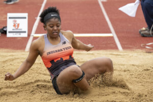 Indiana Tech track athlete completing a long jump