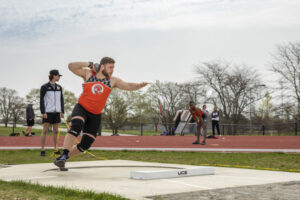 Student preparing to throw a shot during shot put at the Indiana Tech Warrior Park field